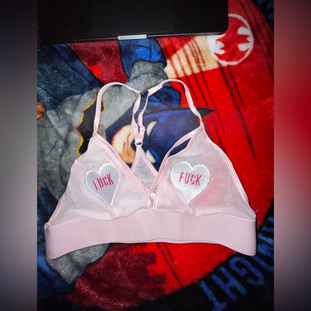 bralette top that says fu** with hearts on the nipples. See through😮‍💨👅